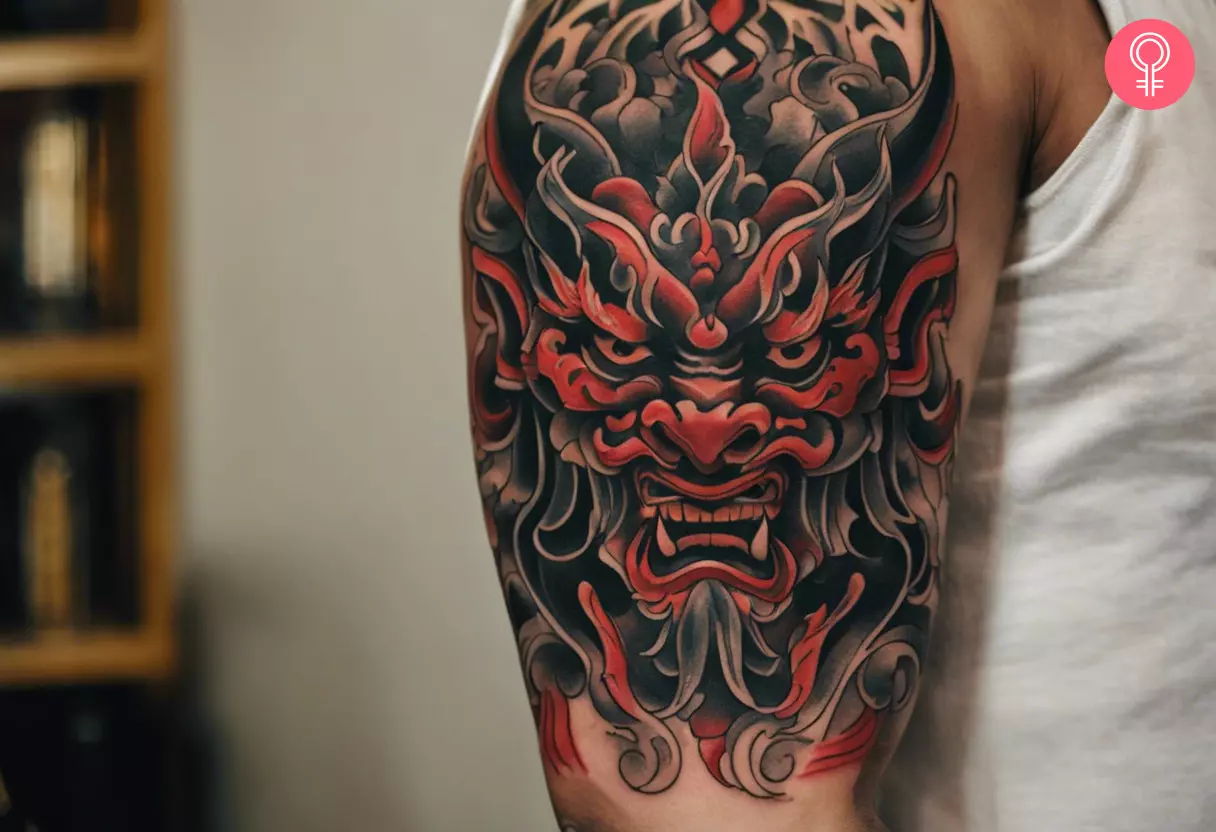 Asian demon tattoo on the upper arm