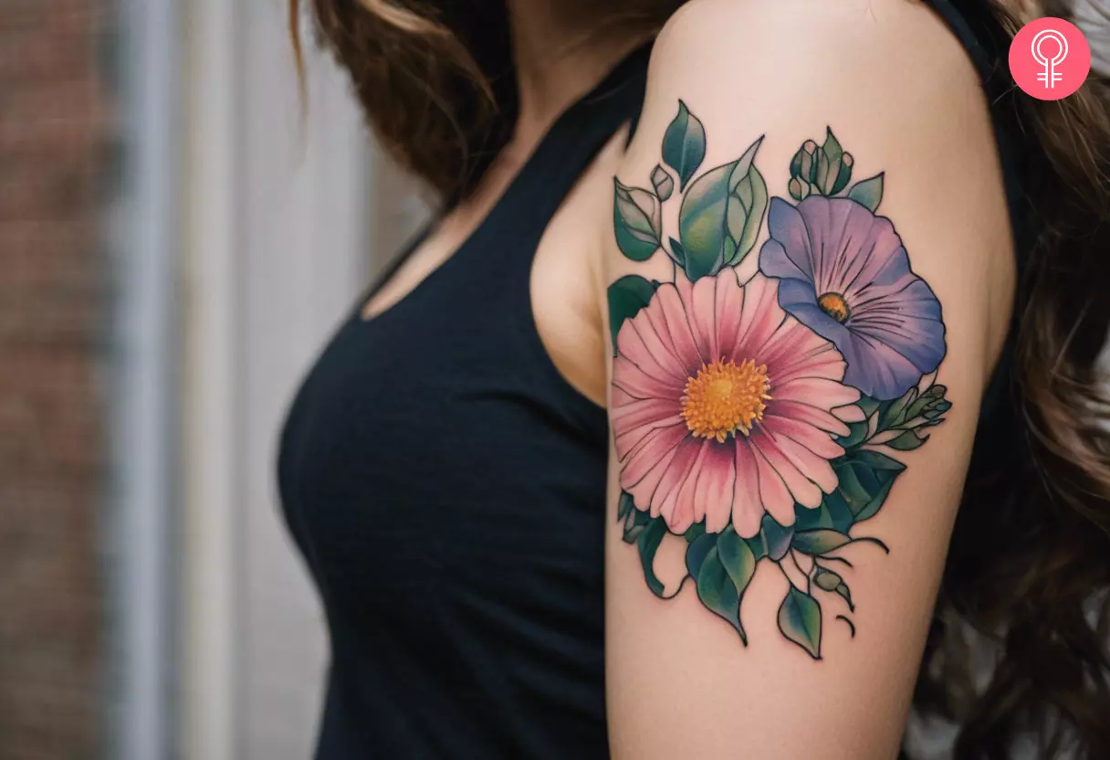 Aster and morning glory flowers tattoo on the upper arm