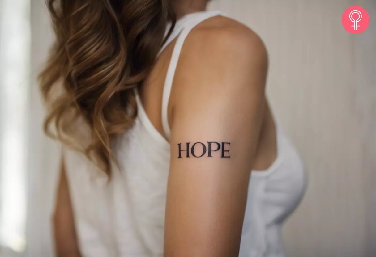 A back of arm tattoo with the word hope