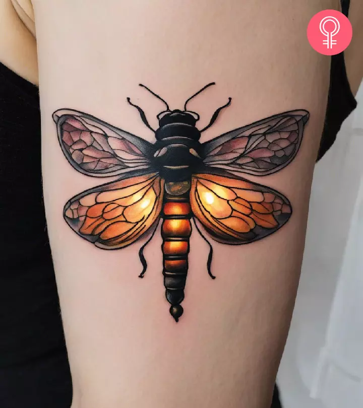 Woman with firefly tattoo on her upper arm