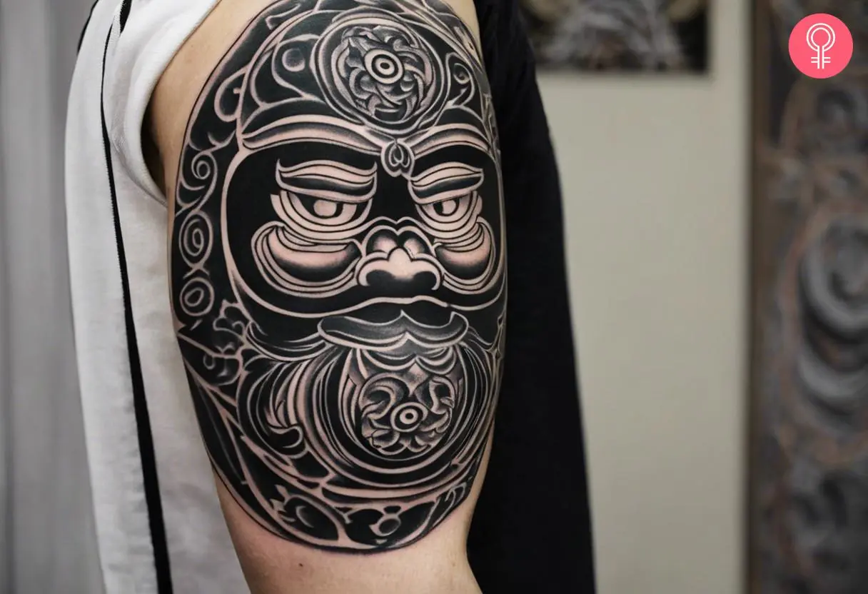 Black Daruma doll tattoo on a man’s arm