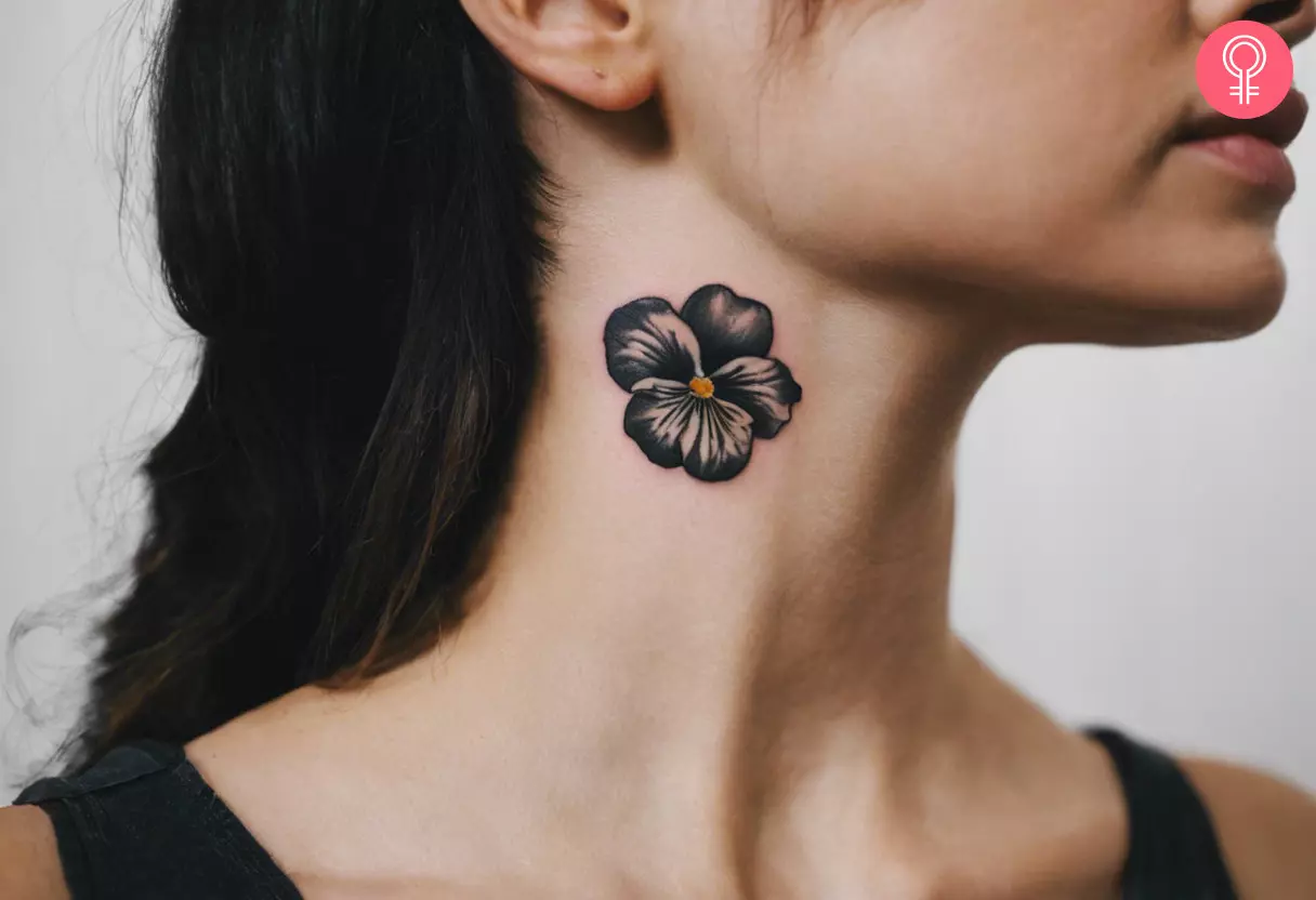 A black Pansy tattoo on the side of the neck