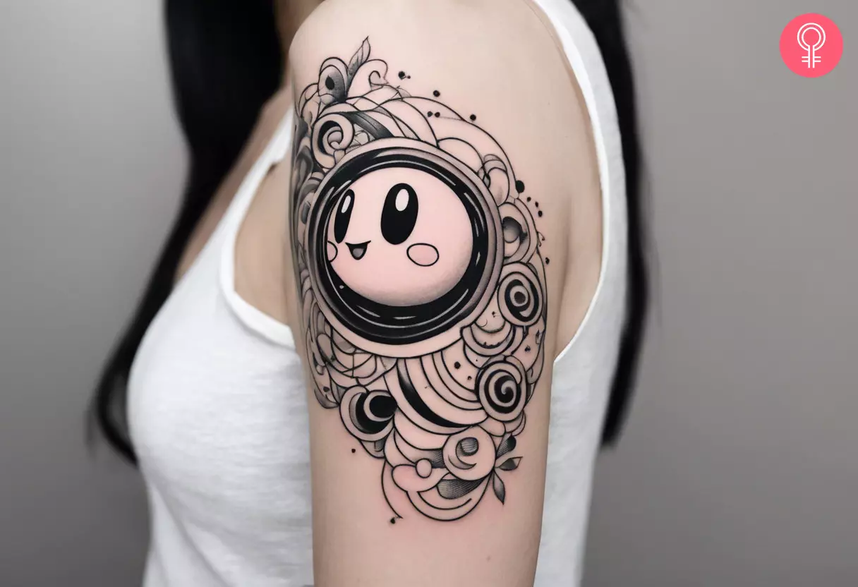 Black and white Kirby Tattoo on the upper arm