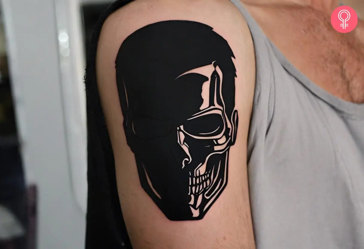 Blackwork terminator tattoo on the upper arm