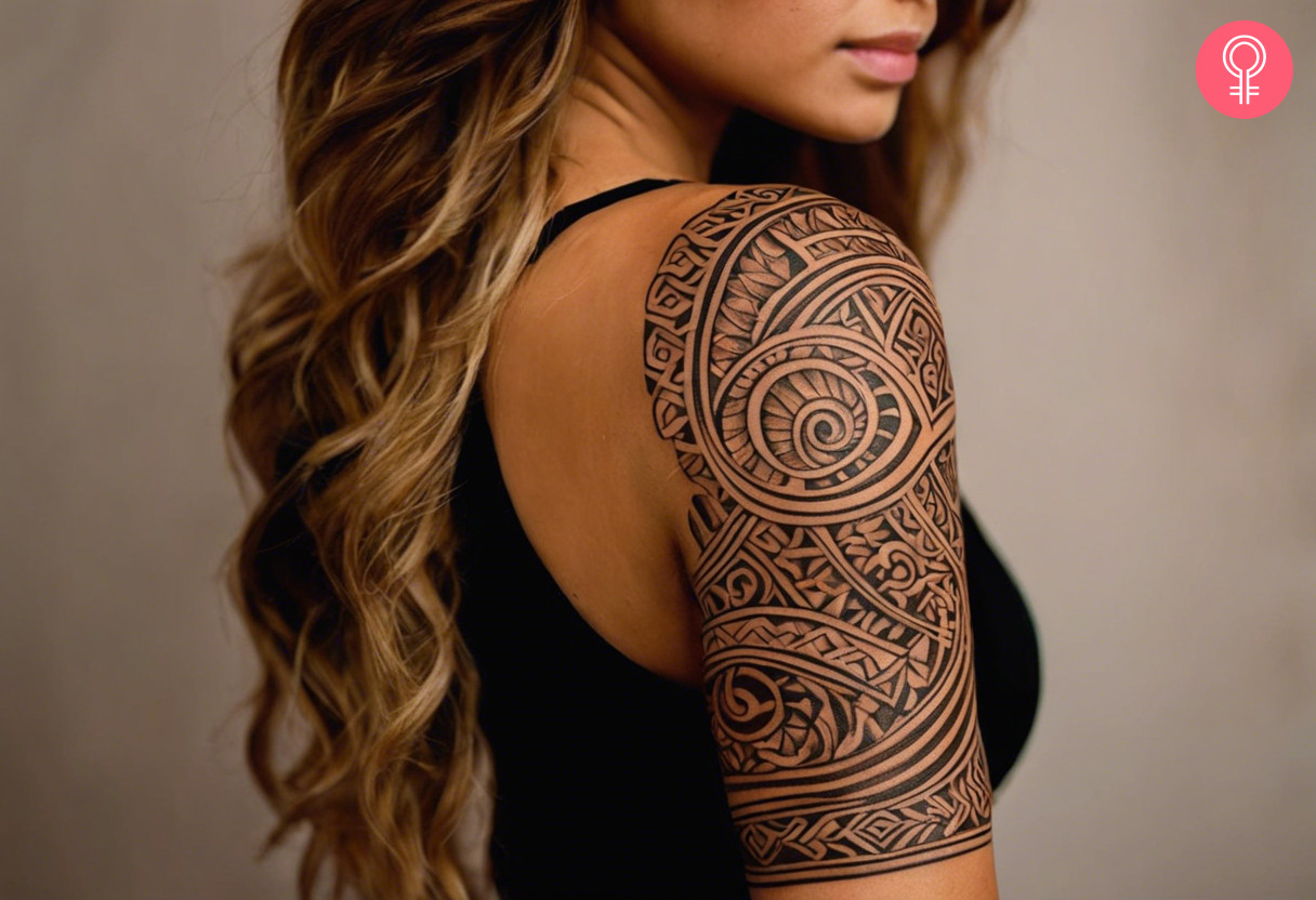 Brown maori tattoo on the upper arm of a woman