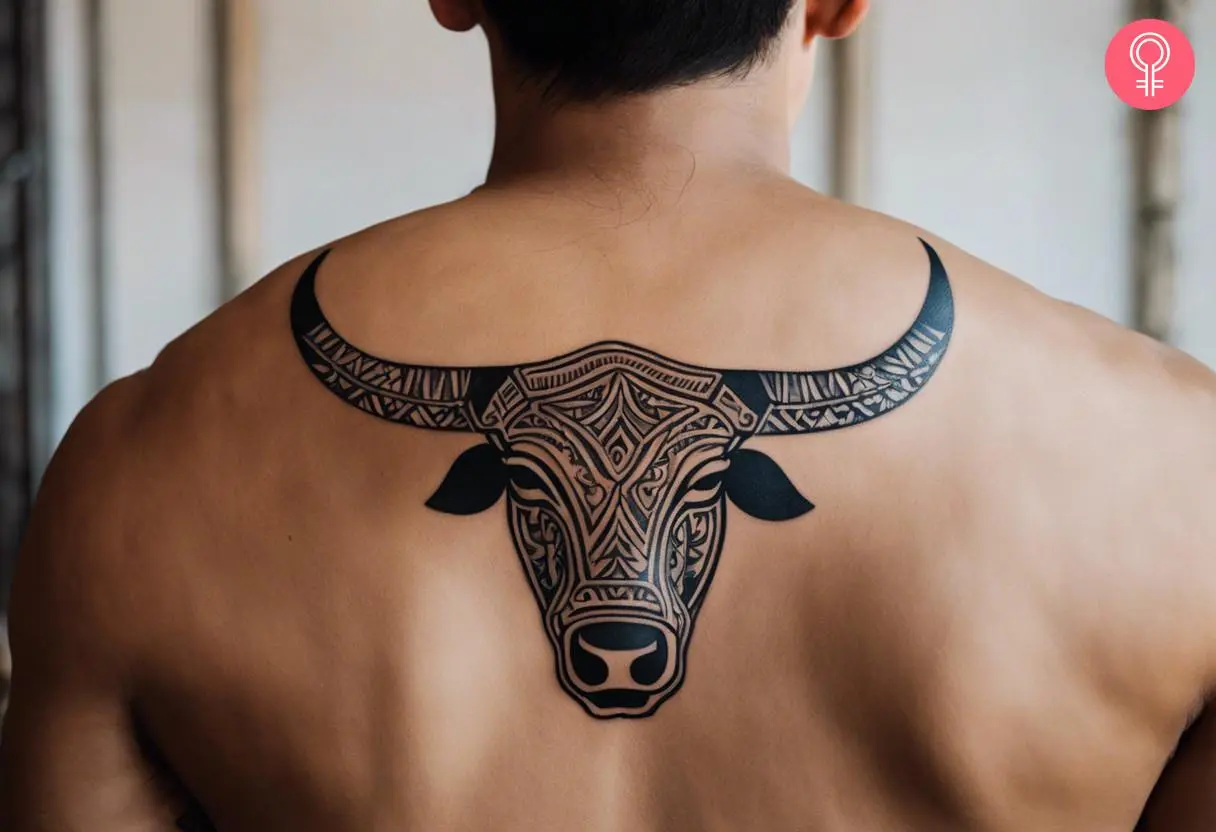 A man with a tribal bull tattoo on his back