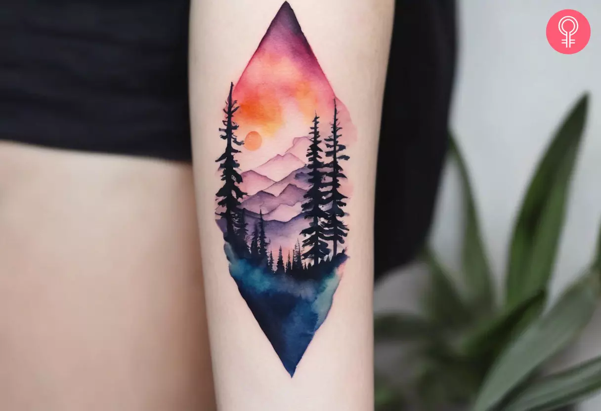 Mountain and forest tattoo on the arm