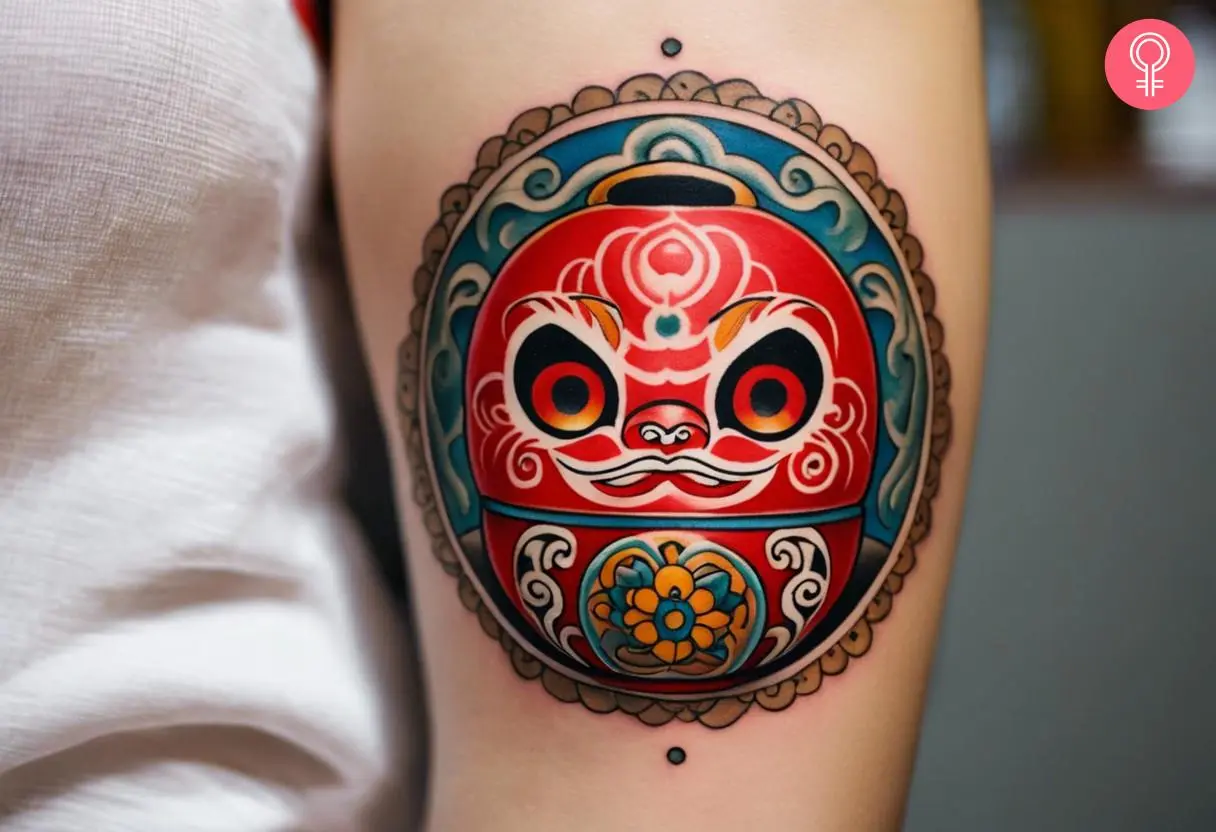 Cute Daruma doll tattoo on a woman’s arm