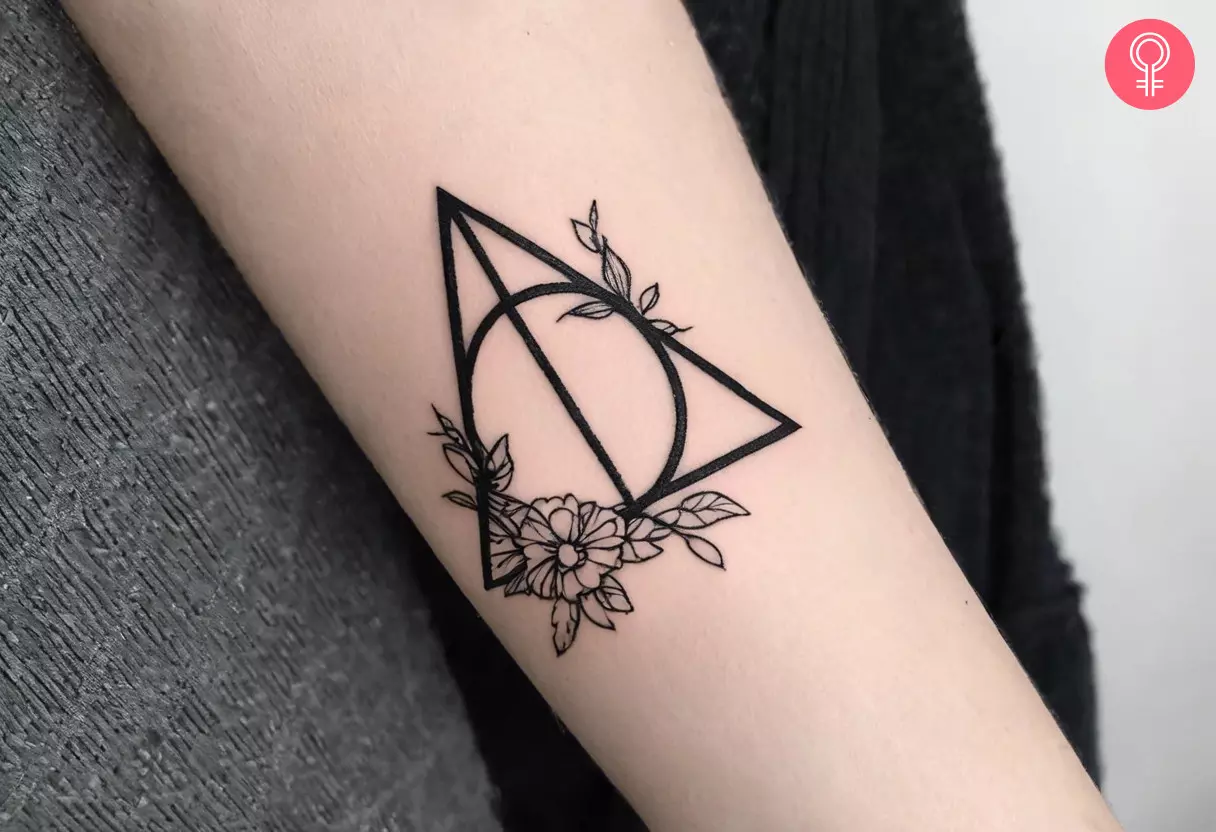 Deathly Hallows floral tattoo on the forearm