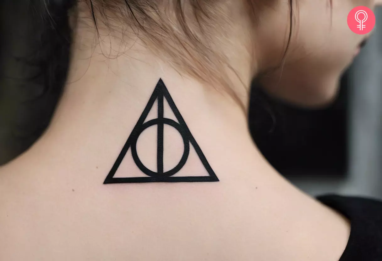 A woman with a Deathly Hallows tattoo on the back of her neck