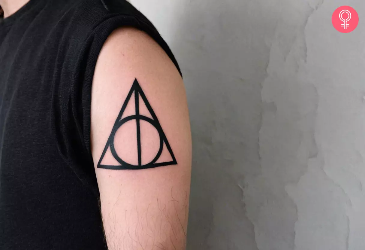 A man with a Deathly Hallows tattoo on his upper arm
