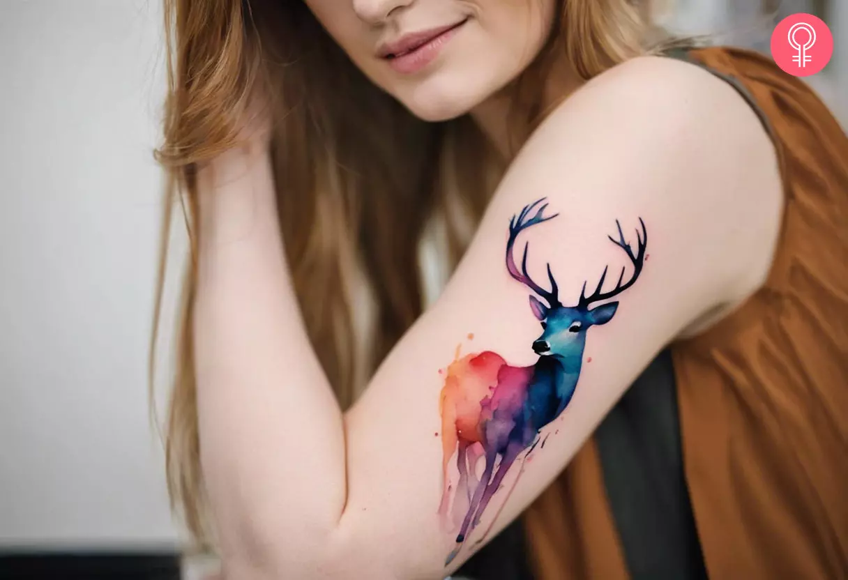Deer watercolor tattoo on a woman’s upper arm