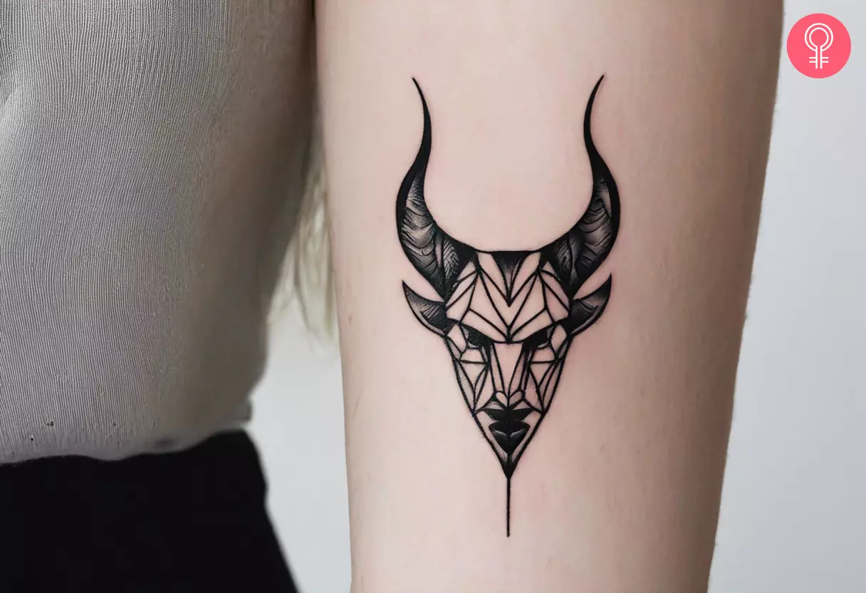 Demon head tattoo on the arm