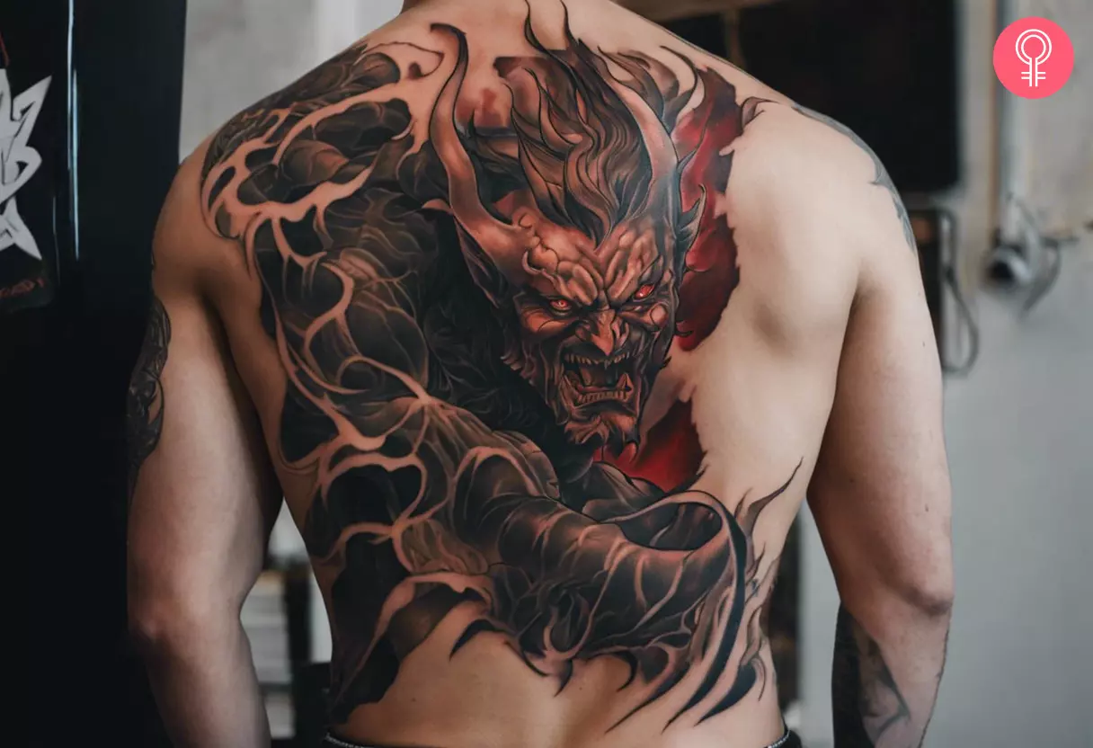 Demon ripping through skin tattoo on the back