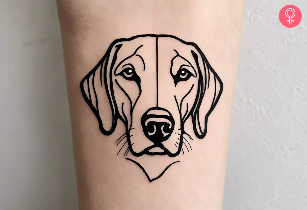 A fine line Labrador tattoo on a woman’s forearm