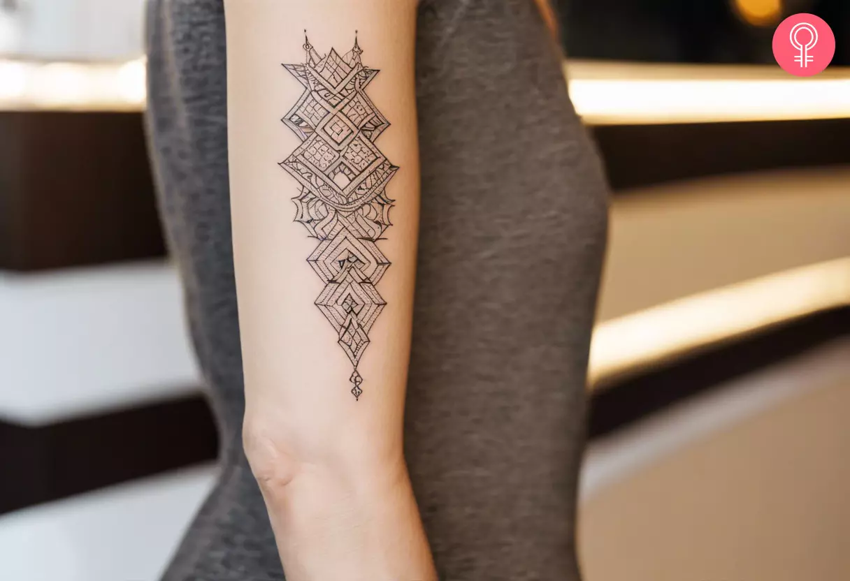 Fine line ornamental tattoo on the upper arm