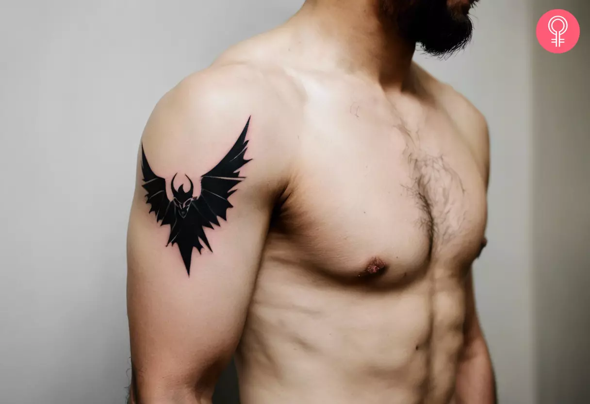 Flying demon tattoo on the upper arm