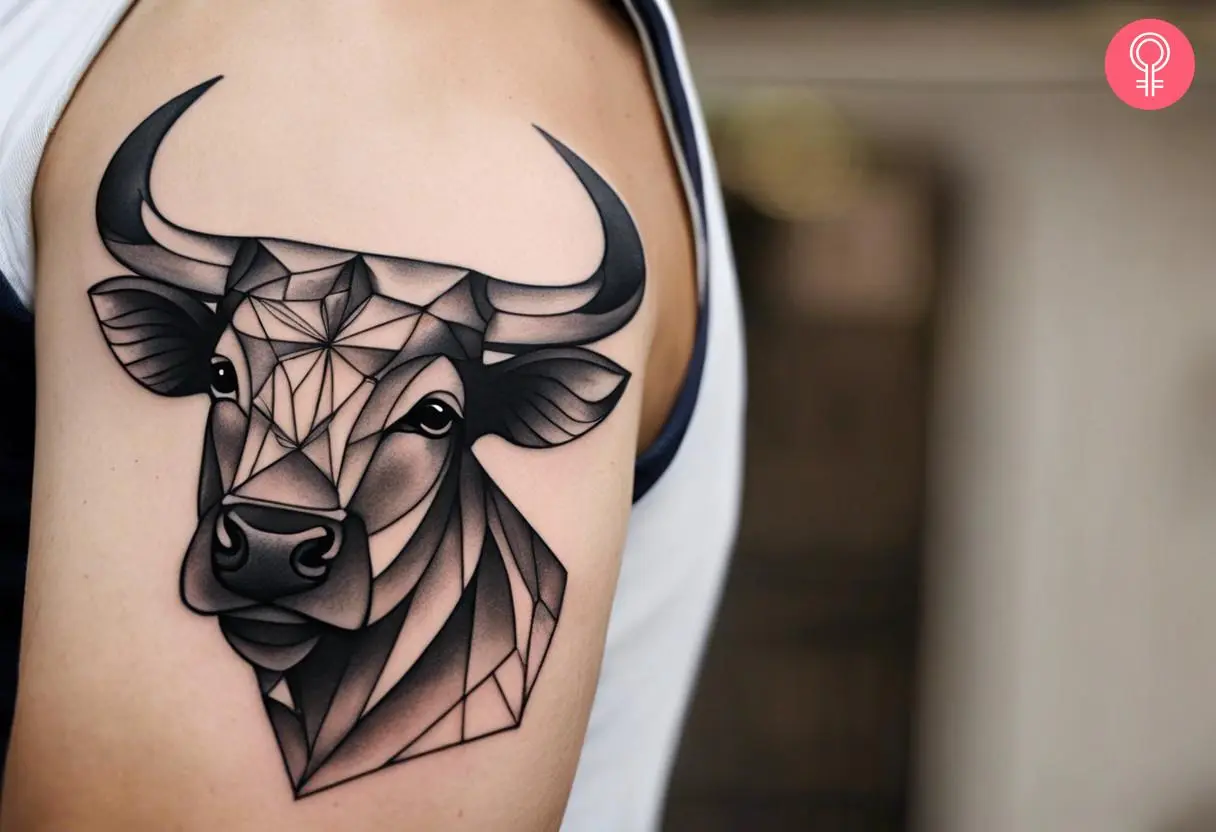 Man with geometric bull tattoo on his upper arm