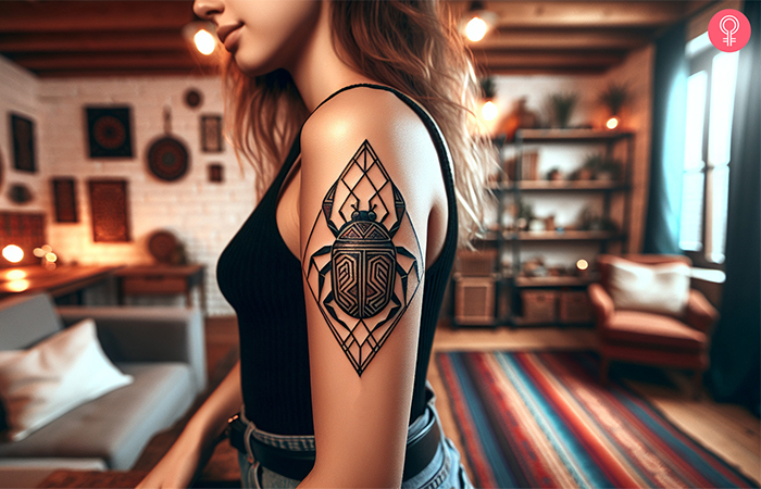 Geometric scarab tattoo on the upper arm