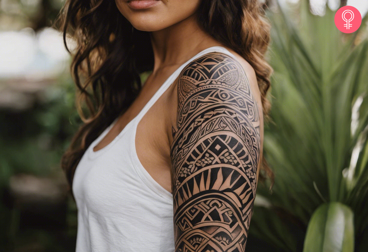 Geometric maori traditional tattoo on the upper arm of a woman