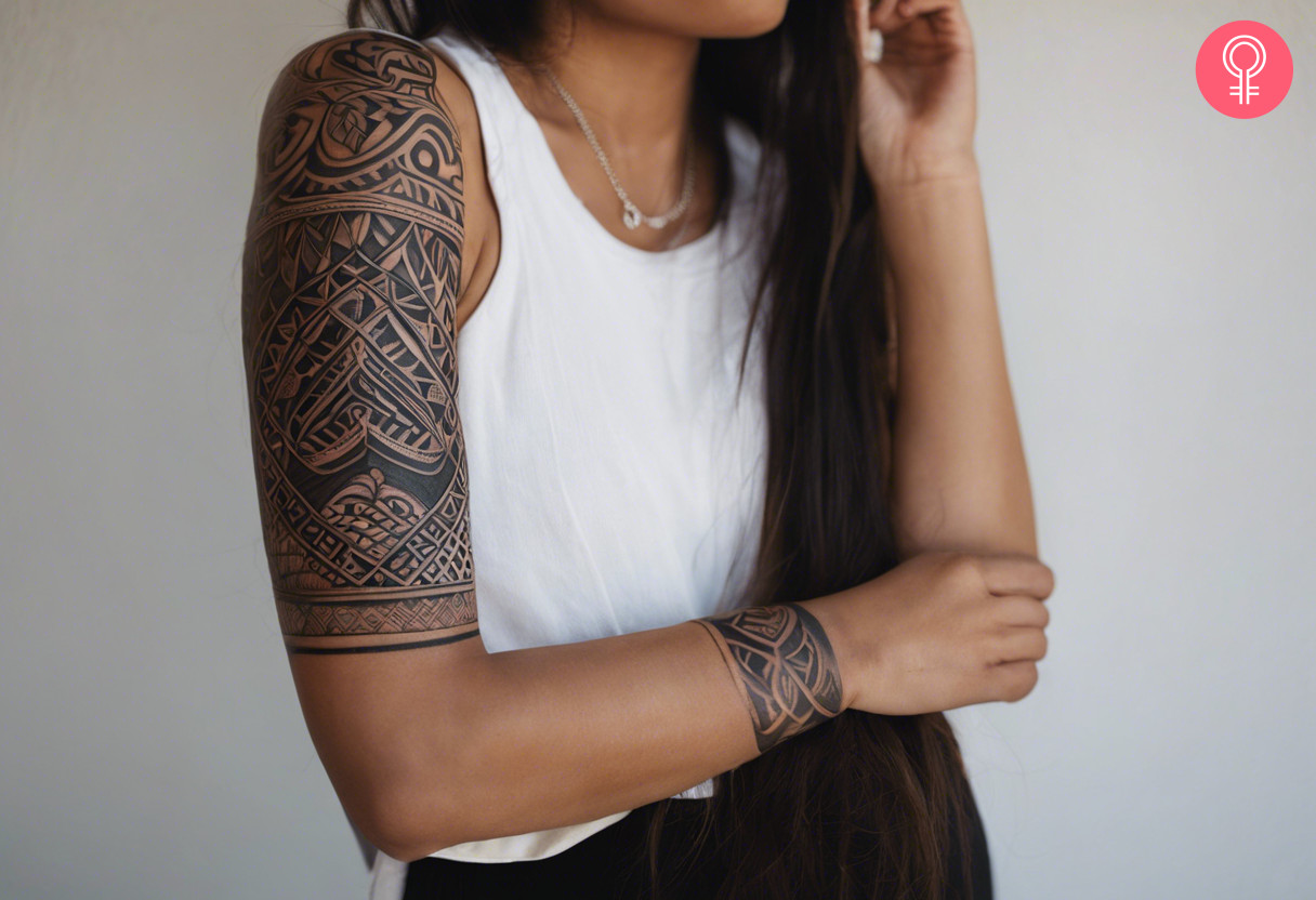 Half sleeve maori tattoo design on the upper arm of a woman