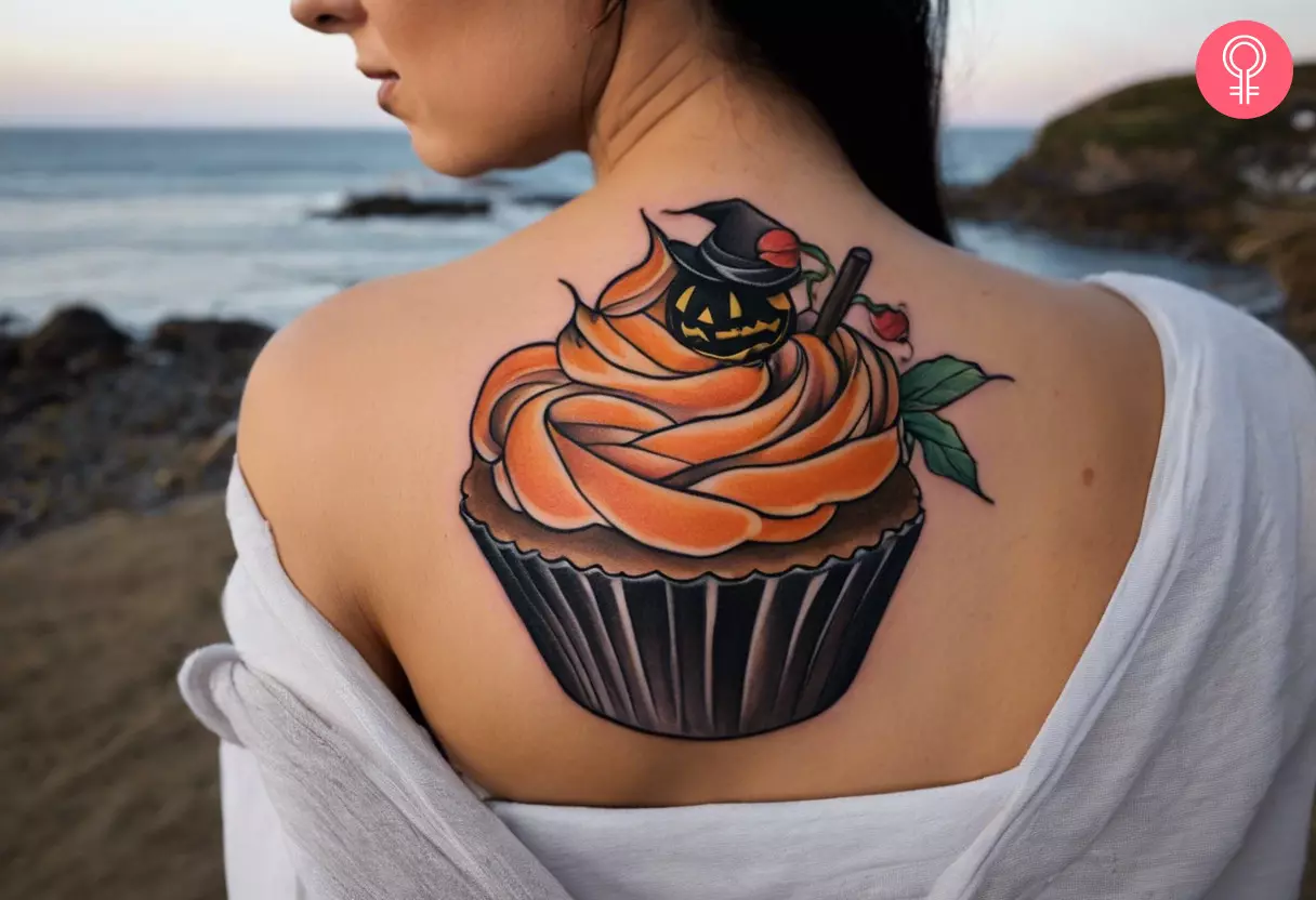 Woman with a Halloween cupcake tattoo on her back