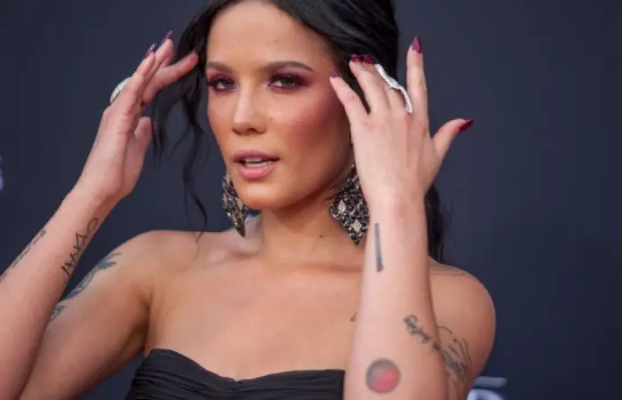 Halsey showing off her venus tattoo on the left forearm