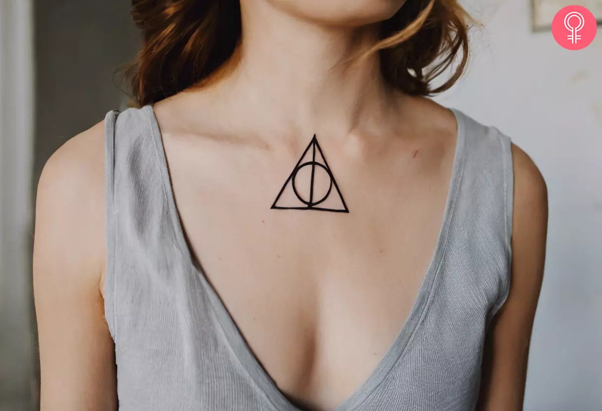 A woman with a Harry Potter Deathly Hallows tattoo below her neck 