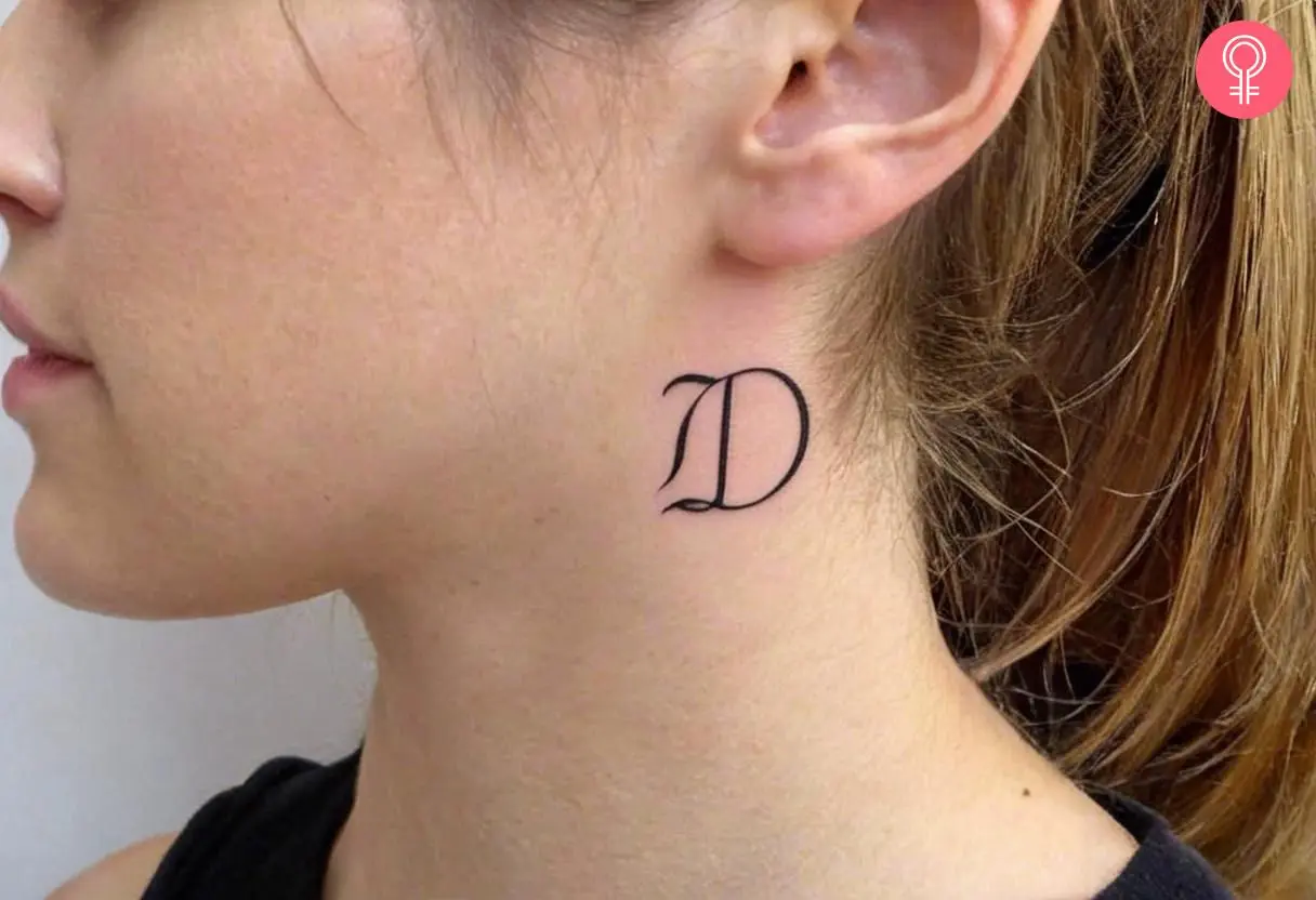 Woman with initial D tattoo on her neck