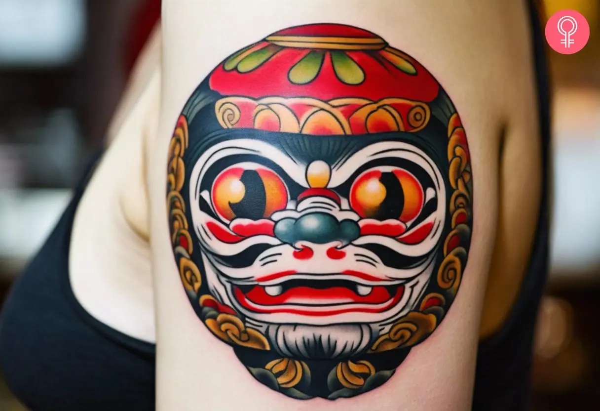 Japanese Daruma doll tattoo on a woman’s arm