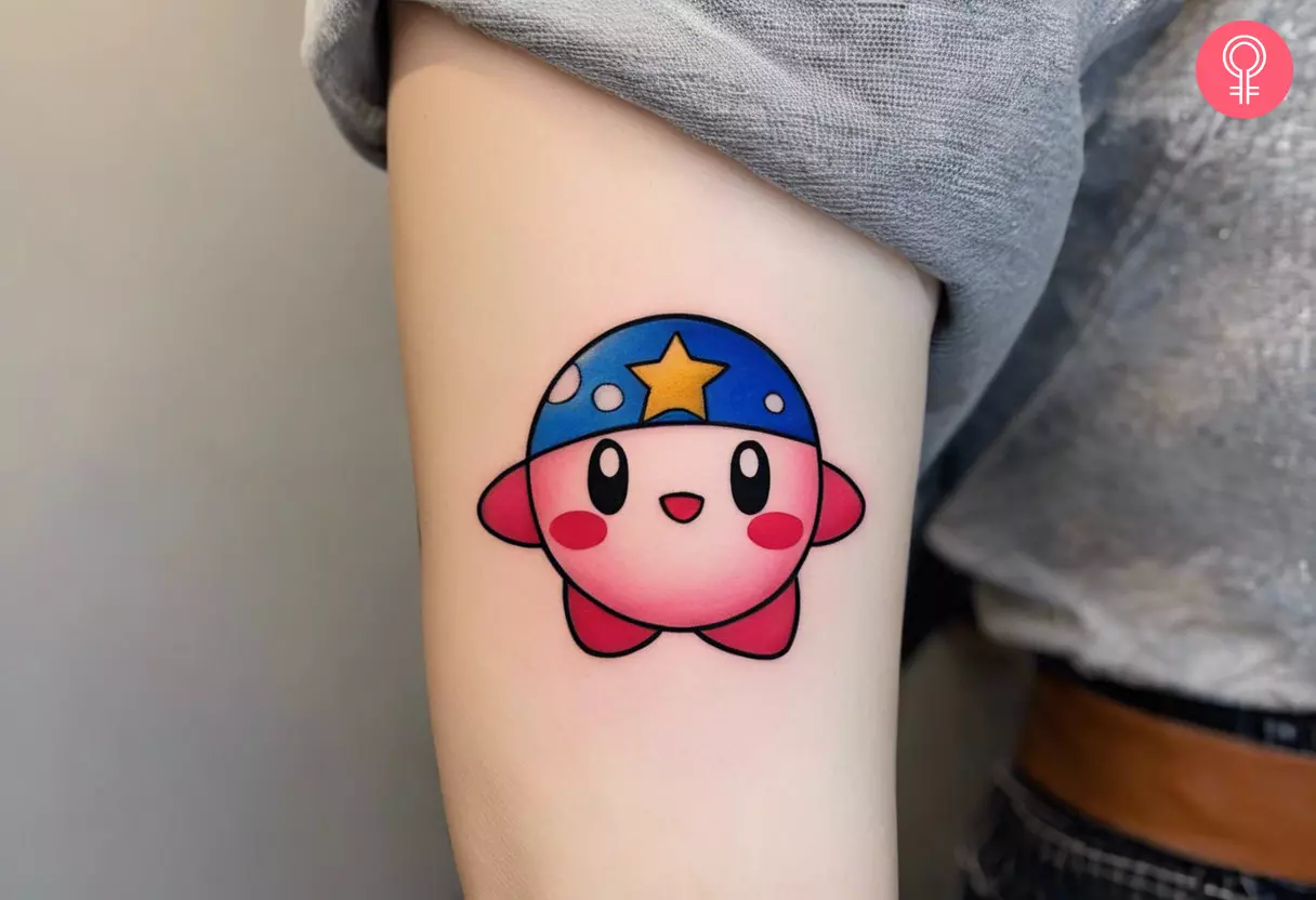 Kirby tattoo on the upper arm with the iconic star