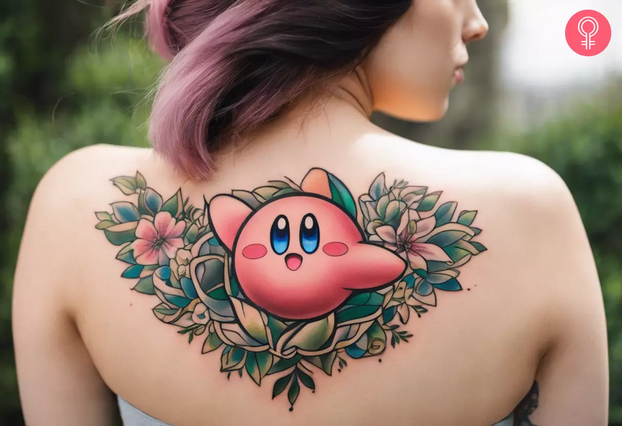 Kirby tattoo with flowers and leaves on the upper back