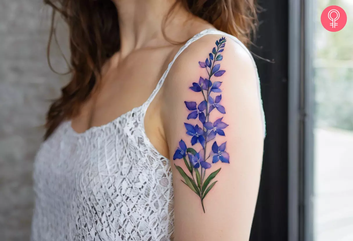 Larkspur flower tattoo on the upper arm