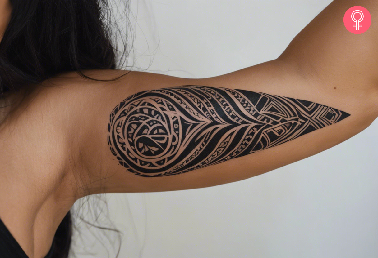 Leaf maori tribal tattoo on the upper arm of a woman