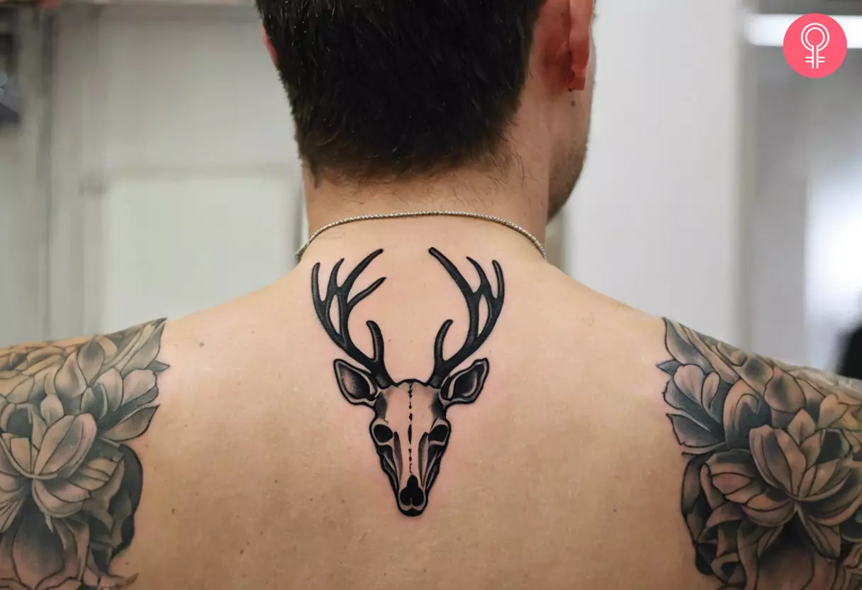 Man with deer skull tattoo on his back