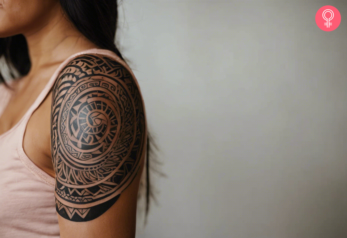 Maori black tattoo on left shoulder of a woman