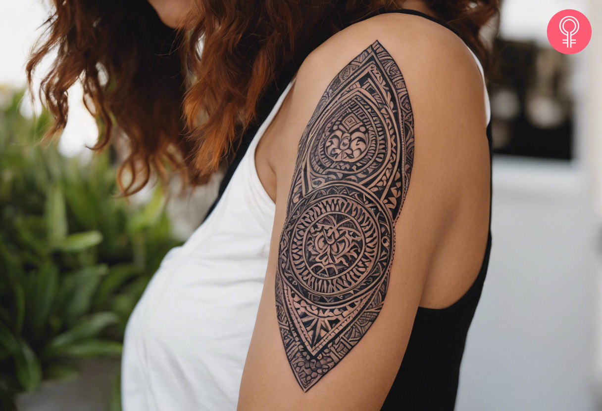 Maori circle and leaf female tattoo on the upper arm