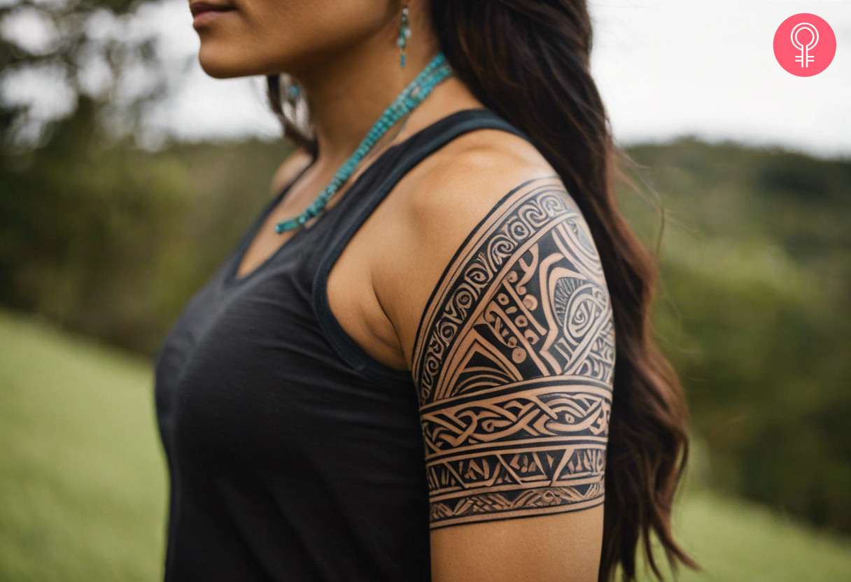 Maori triangular armband tattoo on the upper arm of a woman