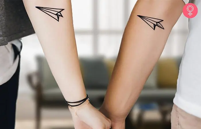 Matching paper airplane tattoos