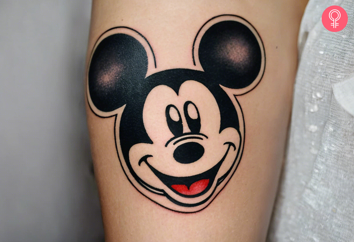 Mickey Mouse head tattoo on the arm