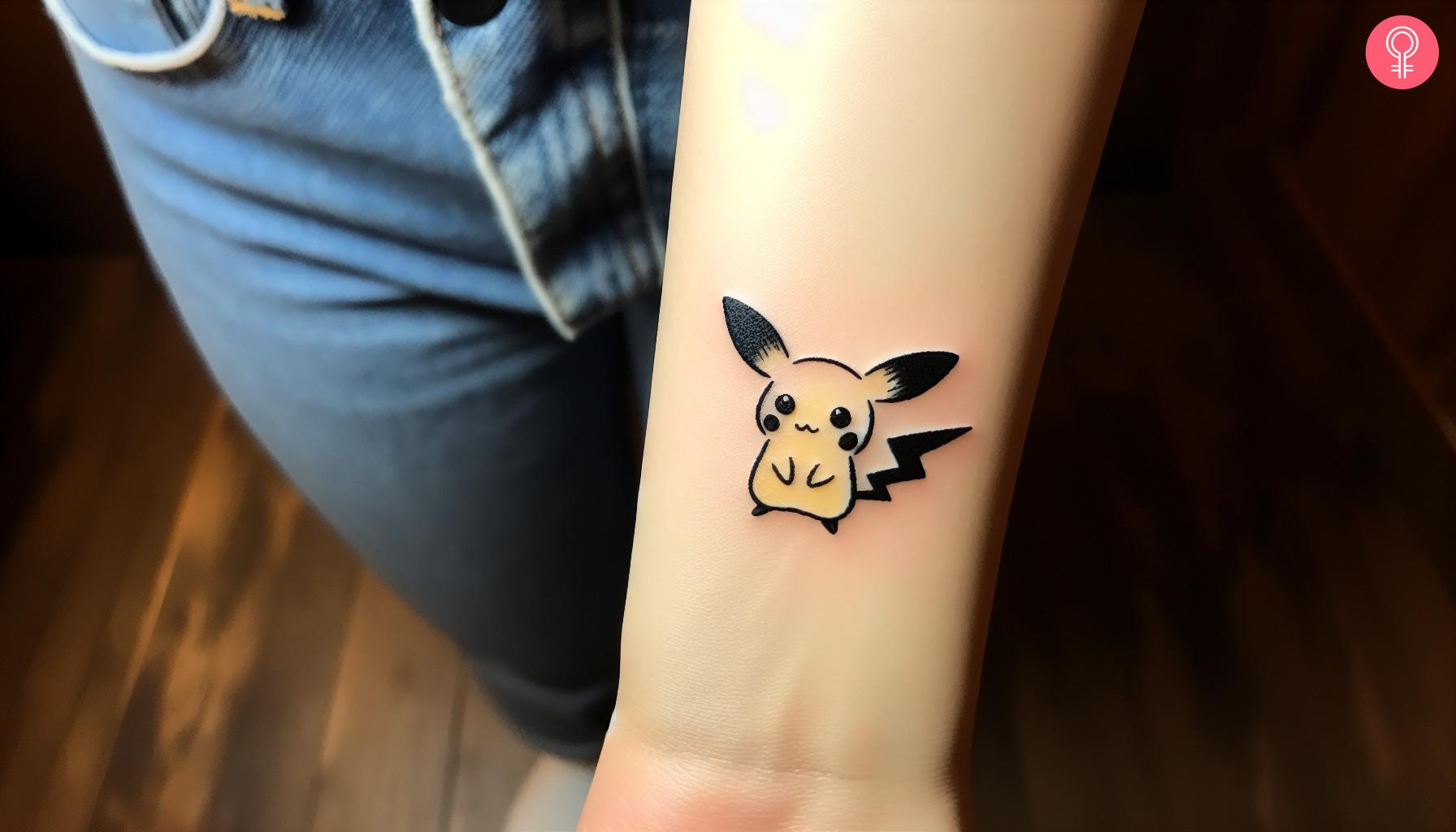 Woman with minimalist anime tattoo on her wrist