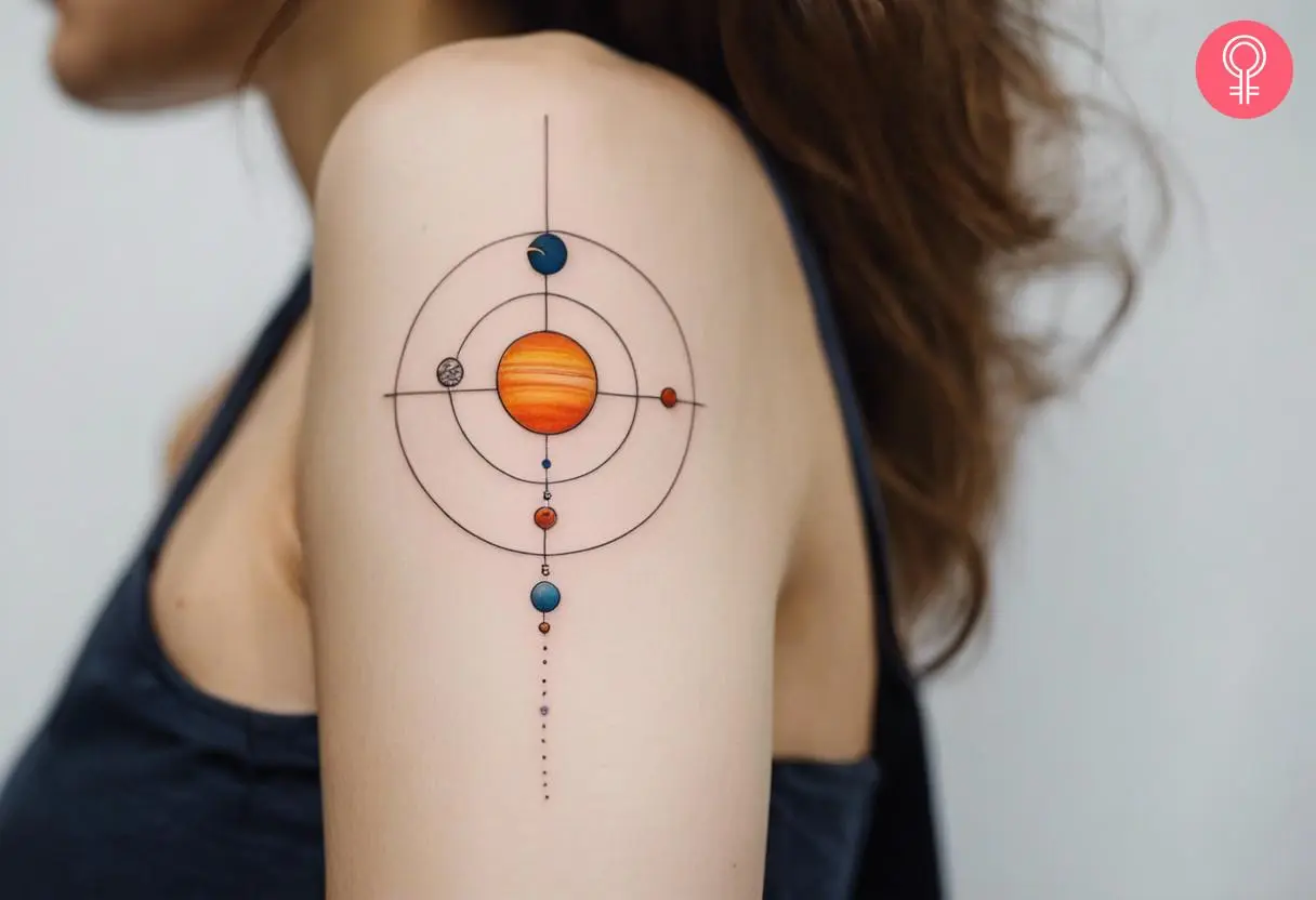 A woman with a simple solar system tattoo on her bicep