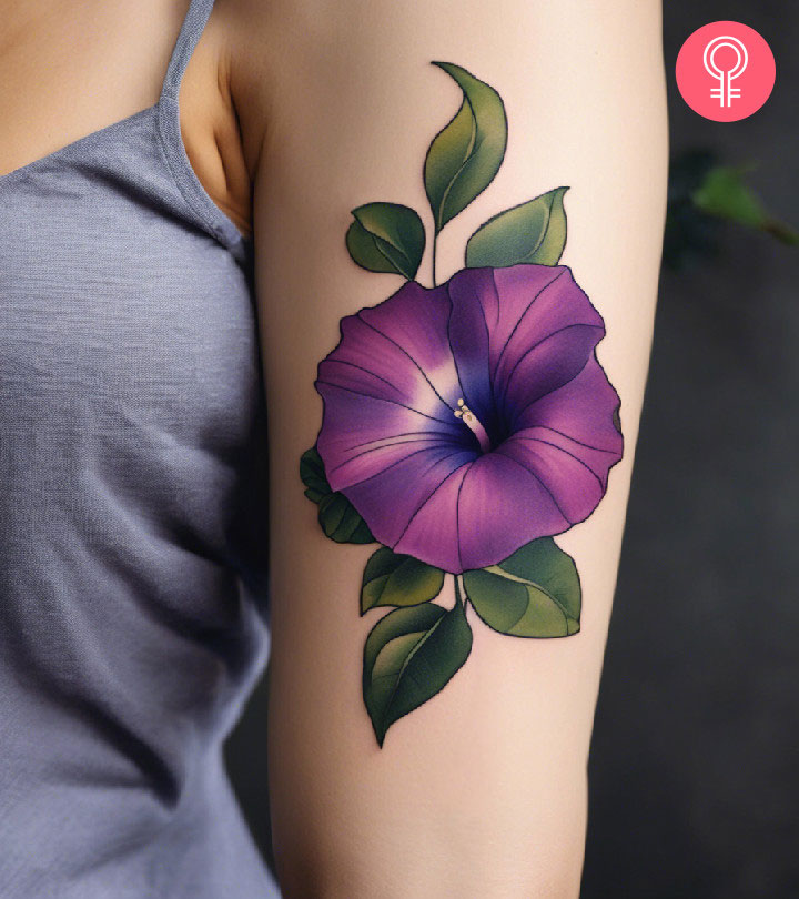 Morning glory flower tattoo on a woman’s upper arm