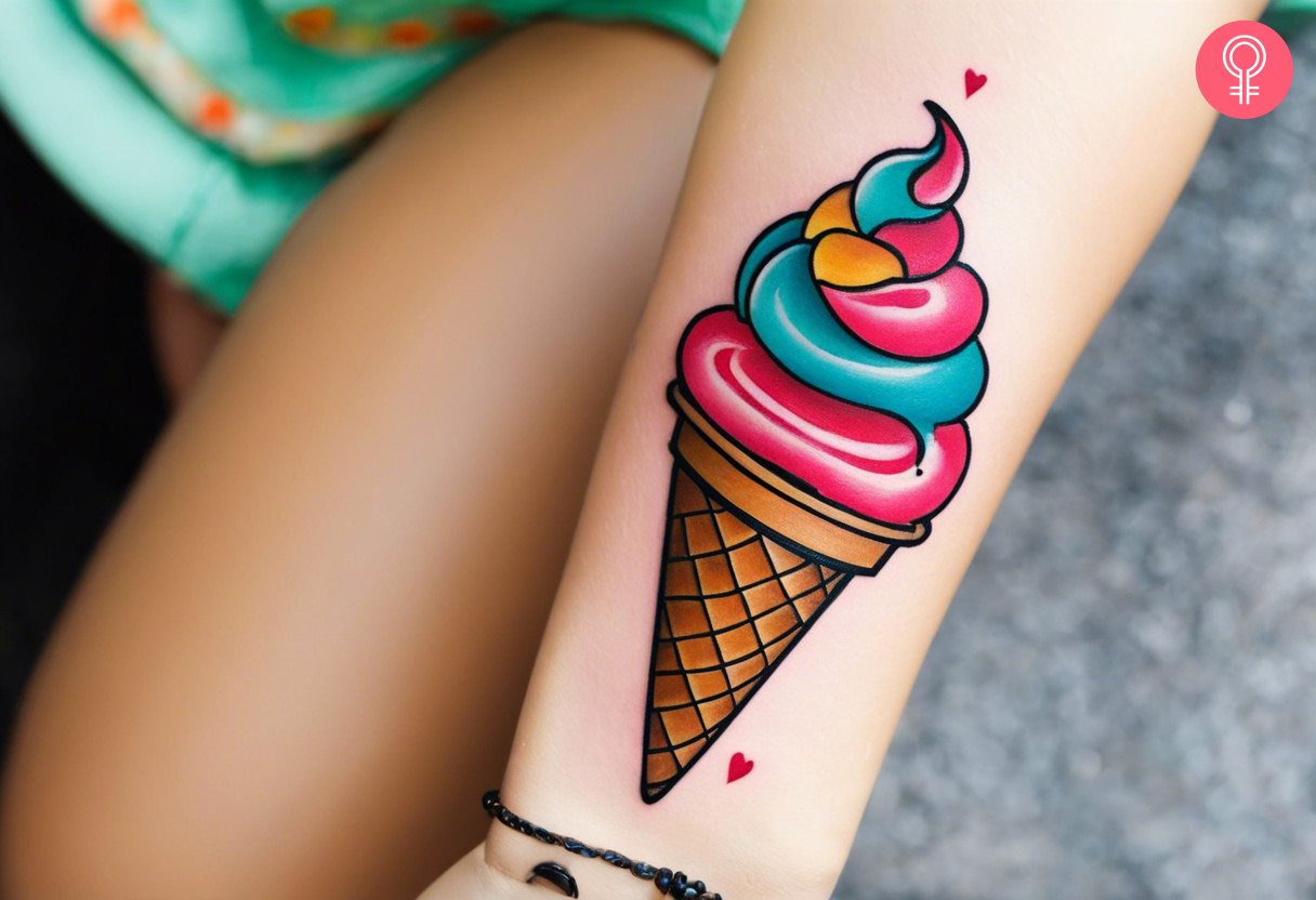 A woman wearing a new school ice cream tattoo on her arm