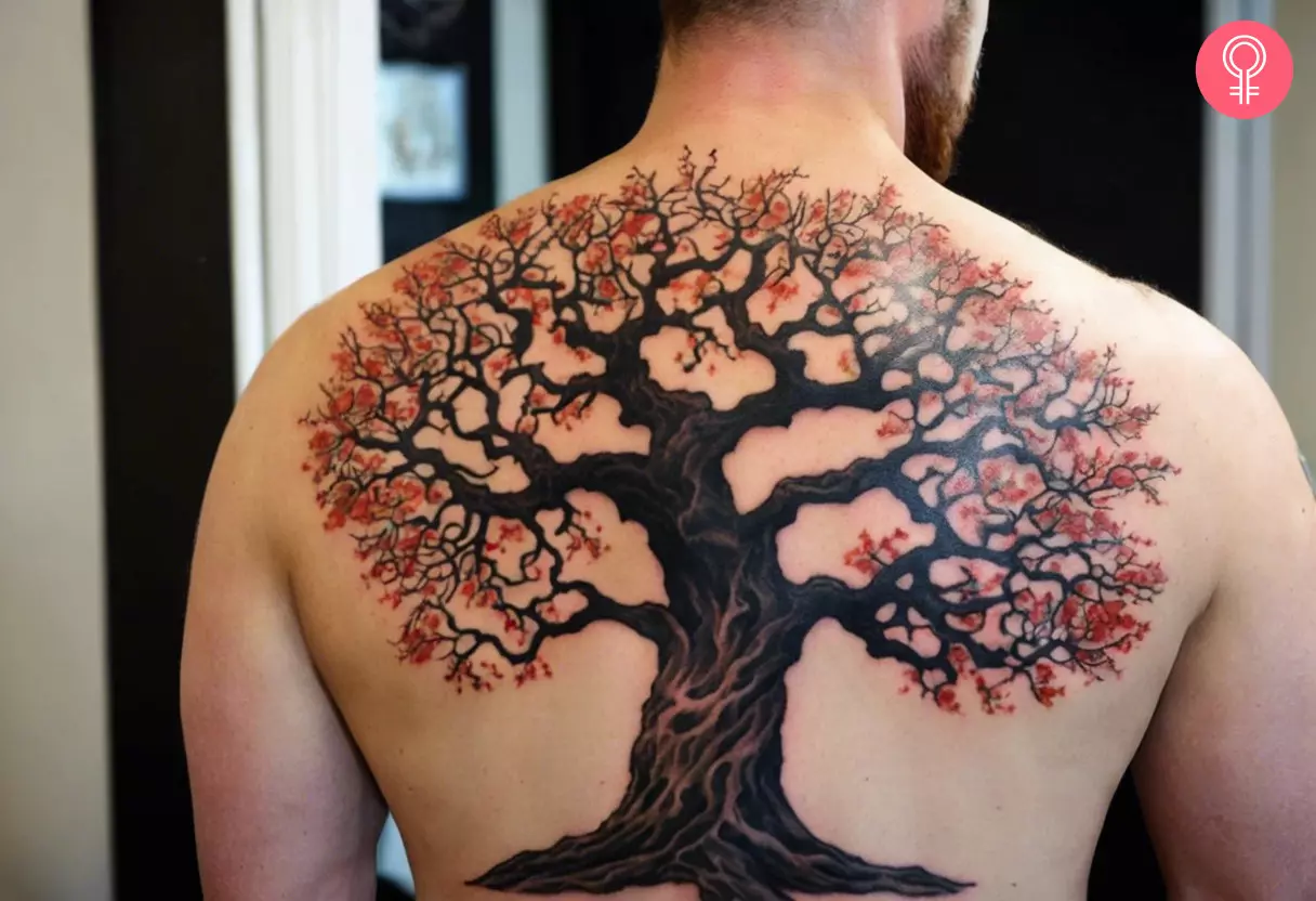 A man with an elaborate oak tree tattoo on his back