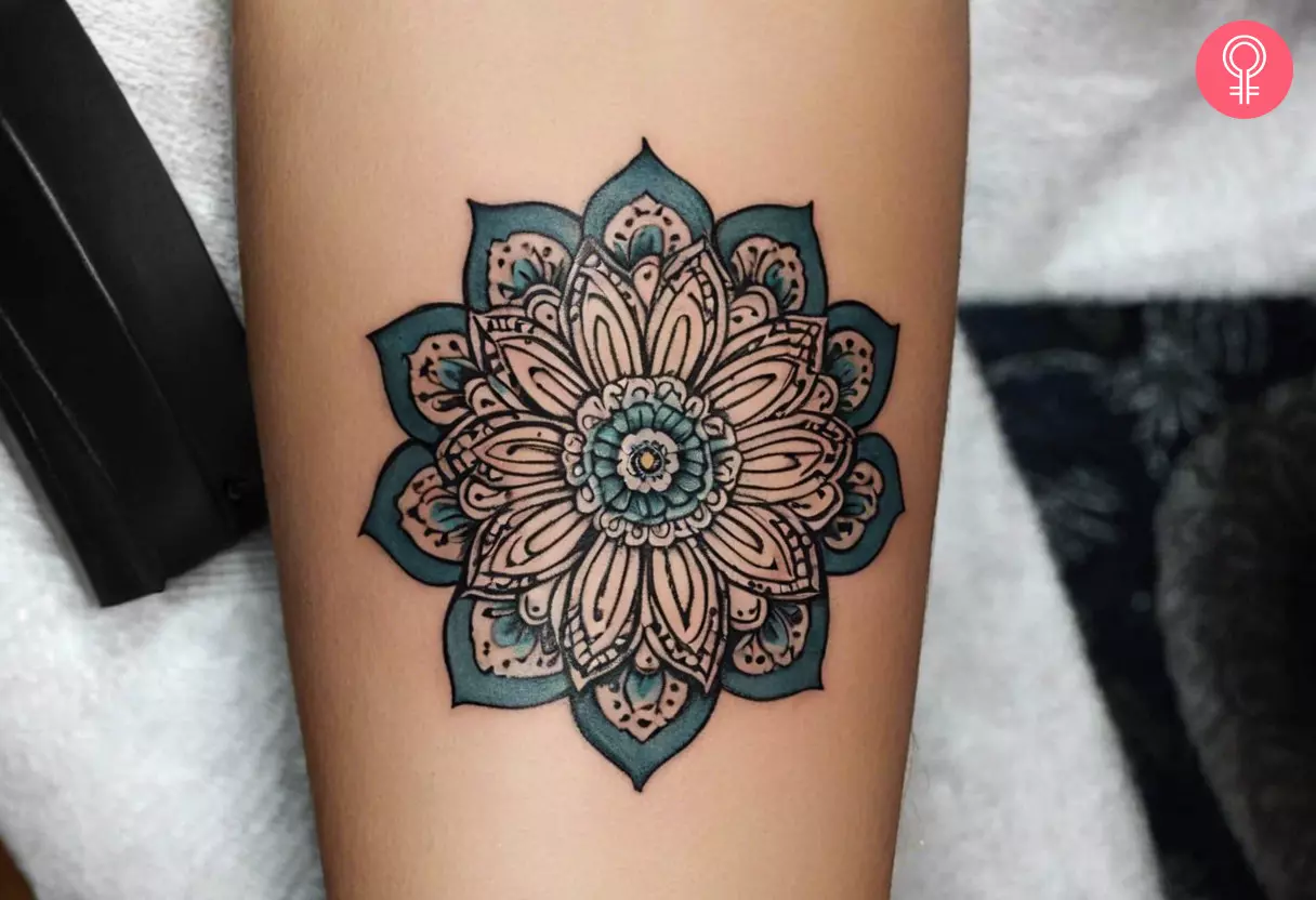 Ornamental flower tattoo on the forearm