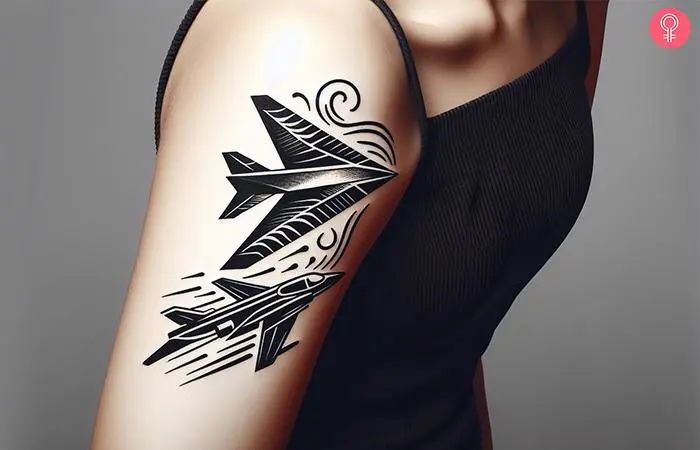 A paper airplane jet tattoo on a woman’s arm