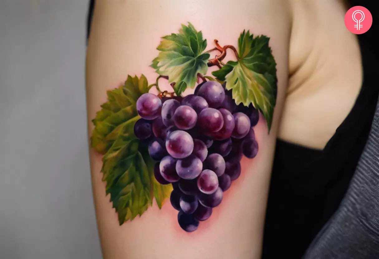 Realistic grapes tattoo on the upper arm