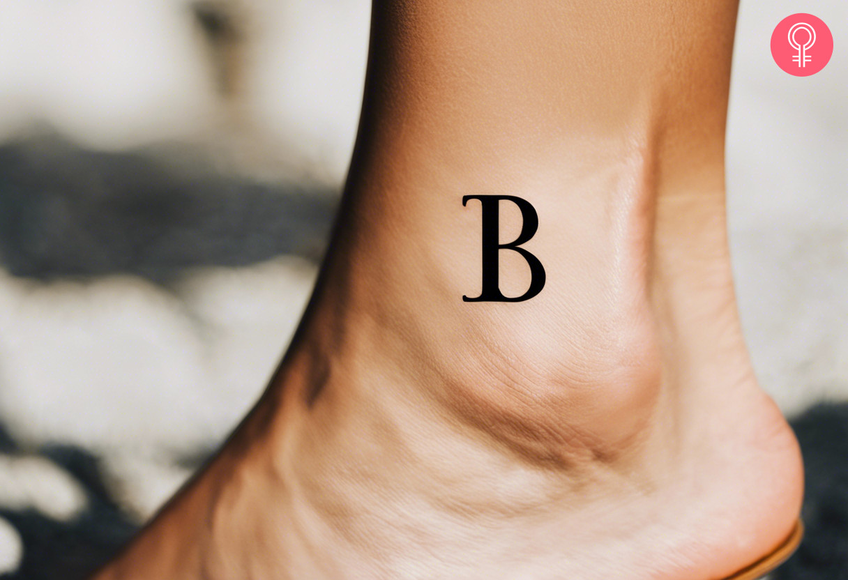Woman with simple initial tattoo on her ankle