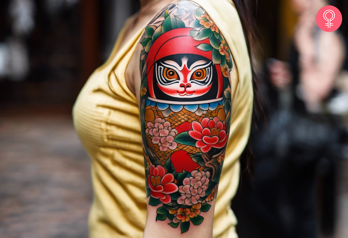 Sleeve tattoo of a Daruma doll on a woman’s arm